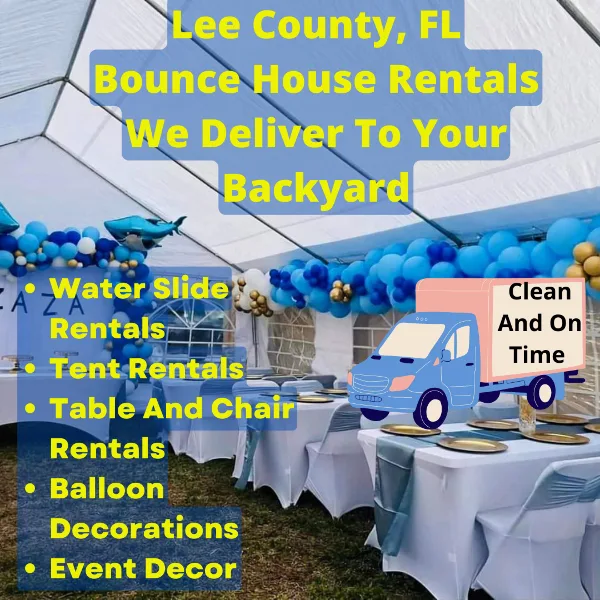 A white event tent set up outdoors with tables, chairs, and blue and gold balloon decorations.
