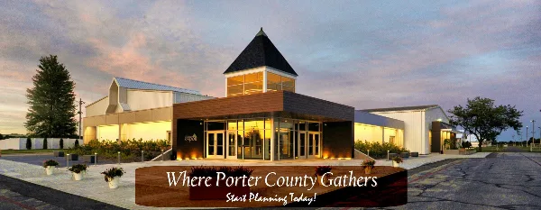 Exterior view of the Porter County Expo Center building at dusk, featuring a central tower and large glass entrance.