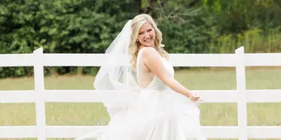 A young bride twirls happily in her elegant wedding dress