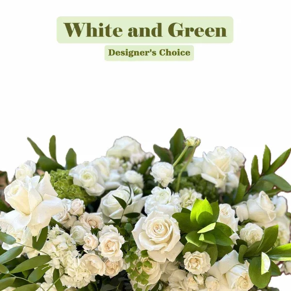 A close-up of a white and green floral arrangement featuring roses and hydrangeas.