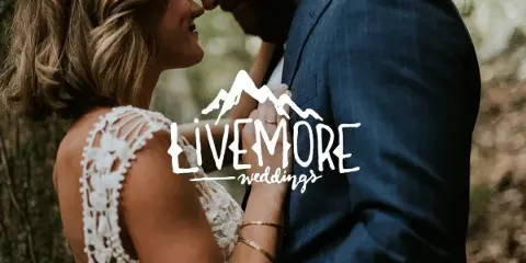 A bride and groom embracing outdoors in a wooded area, with the Livemore Weddings logo overlaid.