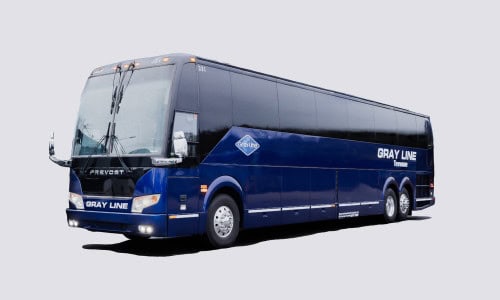 A blue Gray Line motorcoach bus parked against a white background.