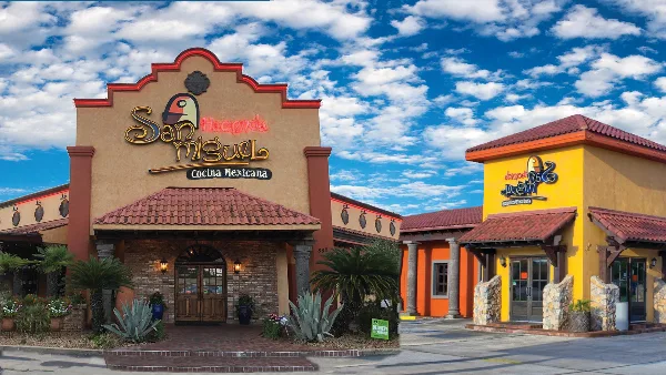 Exterior view of the Hacienda San Miguel Mexican restaurant building featuring Spanish-style architecture, terracotta roofs, and a colorful facade.