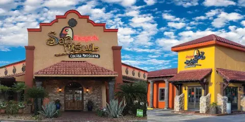 Exterior view of the Hacienda San Miguel Mexican restaurant building featuring Spanish-style architecture, terracotta roofs, and a colorful facade.