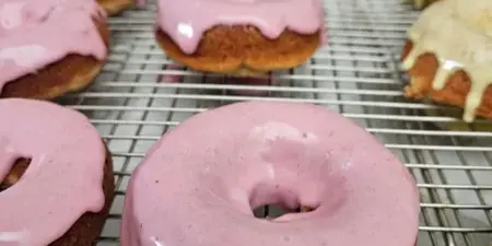 Glazed baked donuts on a wire cooling rack