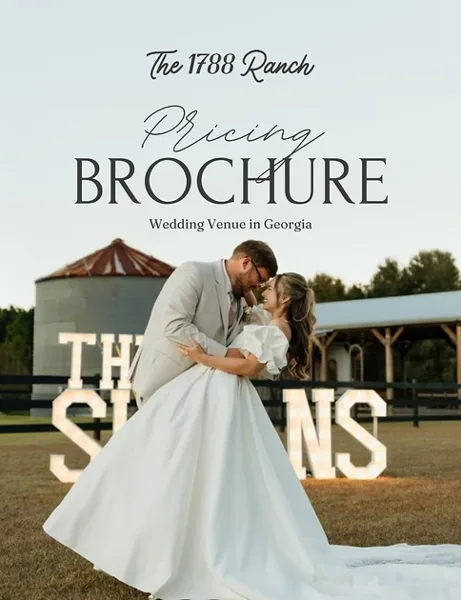A bride and groom dancing in front of a white barn and pavilion at The 1788 Ranch wedding venue.