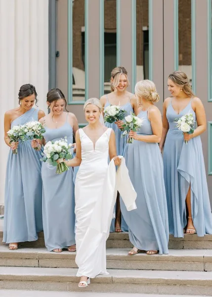 Bride and bridesmaids with styled hair and makeup holding bouquets