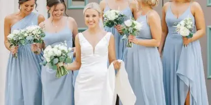Bride and bridesmaids with styled hair and makeup holding bouquets