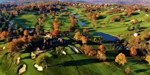 Aerial view of St. Clair Country Club showing the clubhouse, golf course, and surrounding landscape in autumn.