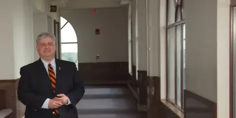 Sangamon County Circuit Clerk Paul Palazzolo standing in the hallway of the Sangamon County Courts Complex.