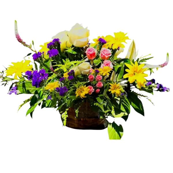 A colorful floral arrangement featuring yellow daisies, pink roses, and purple flowers in a woven basket.