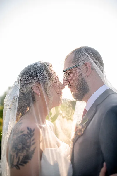 bride and groom at stonewall estate under veil