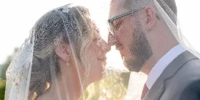 bride and groom at stonewall estate under veil
