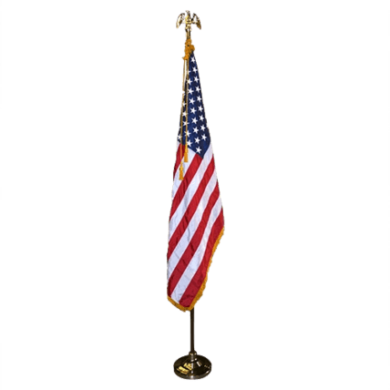 A decorative American flag on a stand with an eagle finial.