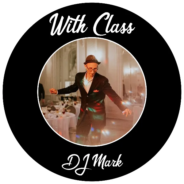 A man in a suit and hat performing as a DJ at a wedding reception.