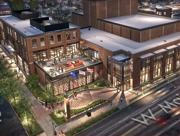 Aerial view of the Hendricks Live! brick building in Plainfield, Indiana, showing its rooftop terrace and street-level entrance.