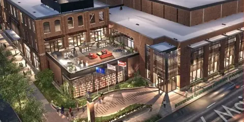 Aerial view of the Hendricks Live! brick building in Plainfield, Indiana, showing its rooftop terrace and street-level entrance.