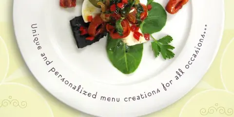 A plated gourmet dish with vegetables and garnish on a white plate.