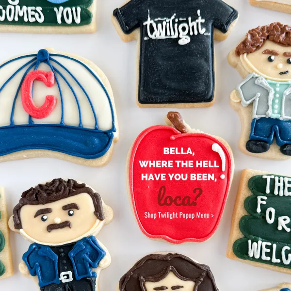 An assortment of intricately decorated iced sugar cookies featuring custom designs and text.