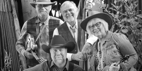 A black and white group portrait of four musicians holding a mandolin, upright bass, and fiddle.