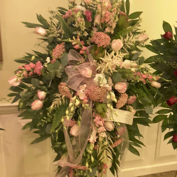 Large pink and white floral standing spray on an easel