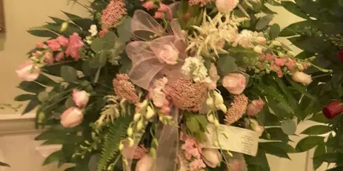 Large pink and white floral standing spray on an easel