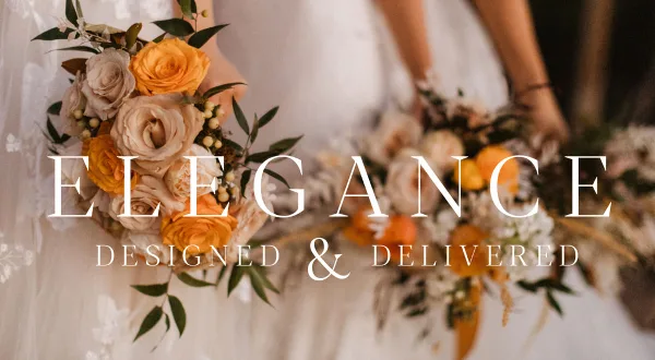 A close-up of a wedding bouquet featuring cream and orange roses held by a bride in a white dress.