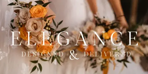 A close-up of a wedding bouquet featuring cream and orange roses held by a bride in a white dress.