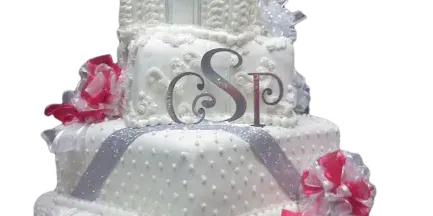 A five-tier white wedding cake with piped detailing, silver ribbons, pink and white floral accents, and a monogram topper.