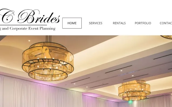 Interior of a wedding venue featuring large, tiered chandeliers and white pipe and drape.