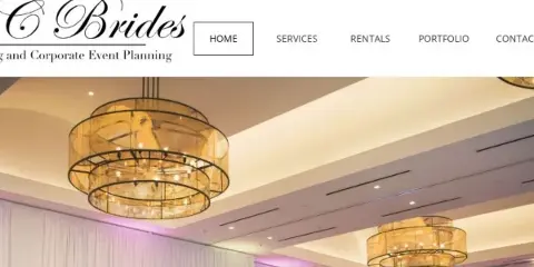 Interior of a wedding venue featuring large, tiered chandeliers and white pipe and drape.