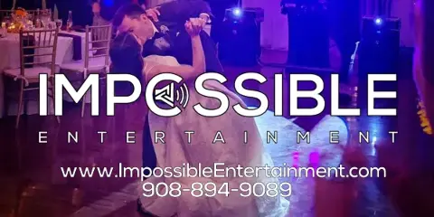 A couple dancing at a wedding reception with professional stage lighting and audio equipment visible in the background.