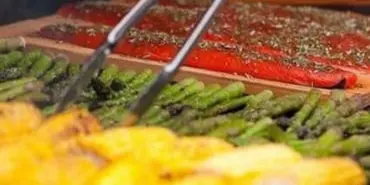 Grilled corn and asparagus beside cedar-planked salmon
