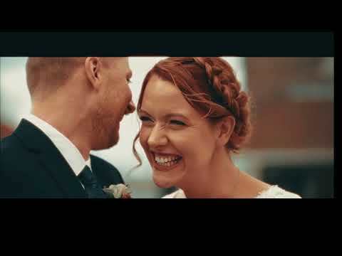A cinematic close-up of a smiling bride and groom sharing a moment during their wedding.