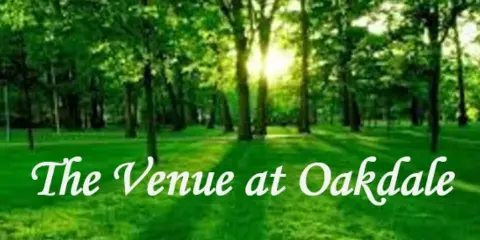 A lush green outdoor area with trees and grass, overlaid with the text 'The Venue at Oakdale'.