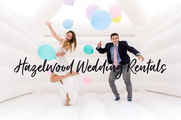 A bride and groom dancing inside a white bounce house with pastel balloons, with the Hazelwood Wedding Rentals name overlaid.