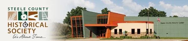 Exterior view of the Steele County History Center building featuring modern architecture with orange and green accents.
