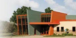 Exterior view of the Steele County History Center building featuring modern architecture with orange and green accents.