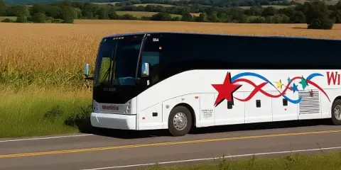 A white Windstar Lines motorcoach driving on a rural road with a cornfield in the background.