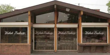 Exterior view of the Weber's Bakery brick storefront with large display windows bearing the business name.