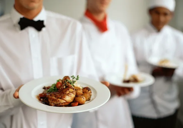 Cafe Orleans Catering — waitstaff holding plated dishes, Harahan, Louisiana