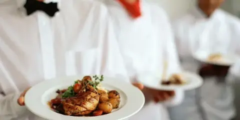 Cafe Orleans Catering — waitstaff holding plated dishes, Harahan, Louisiana