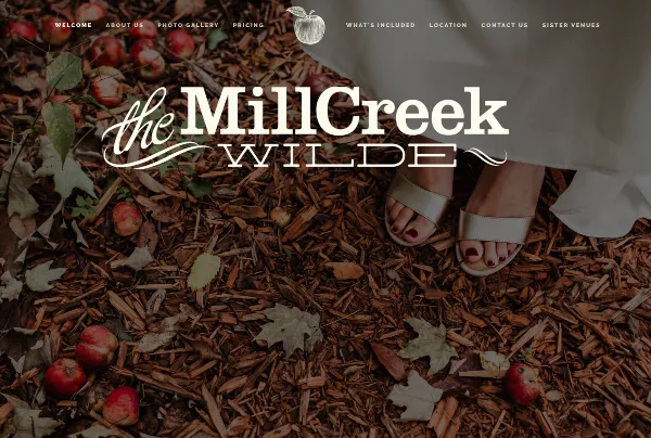 Bride's feet in a white dress and sandals standing on wood mulch with fallen apples