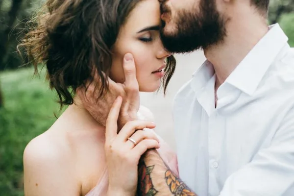 A bride and groom sharing an intimate moment during a wedding ceremony.
