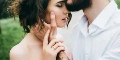 A bride and groom sharing an intimate moment during a wedding ceremony.