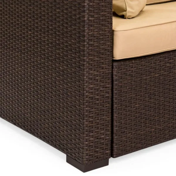 Close-up of a dark brown wicker outdoor sofa with beige cushions.