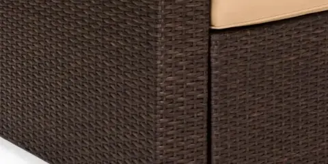 Close-up of a dark brown wicker outdoor sofa with beige cushions.