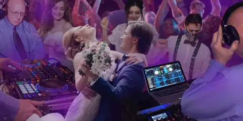 A DJ wearing headphones operates a mixing console and laptop while a bride and groom dance at a wedding reception.