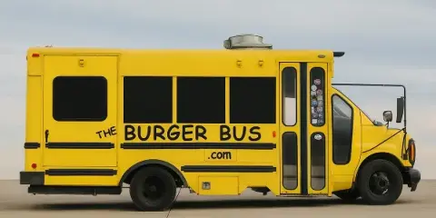 A yellow school bus converted into a food truck with 'The Burger Bus' branding on the side.