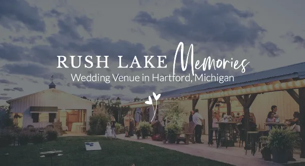 Exterior view of a country-chic wedding venue featuring a large pole barn and an outdoor patio area with guests dining at dusk.